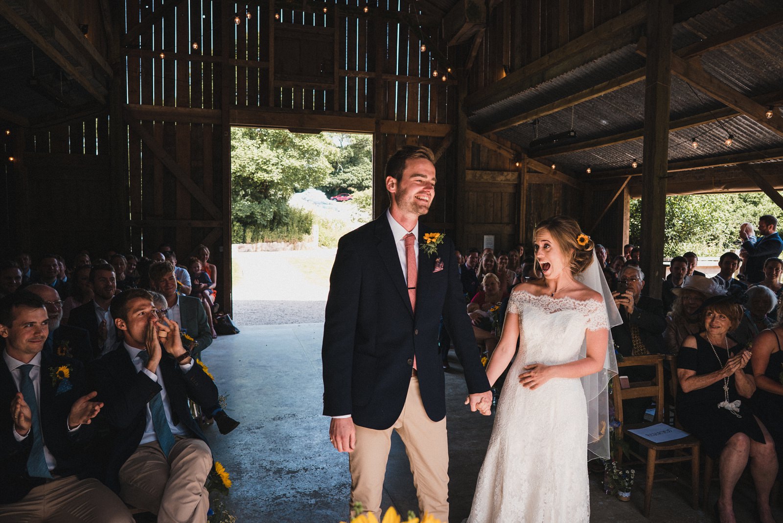 The bride, groom and guests celebrate after the first kiss at their wedding ceremony in Nancarrow Farm
