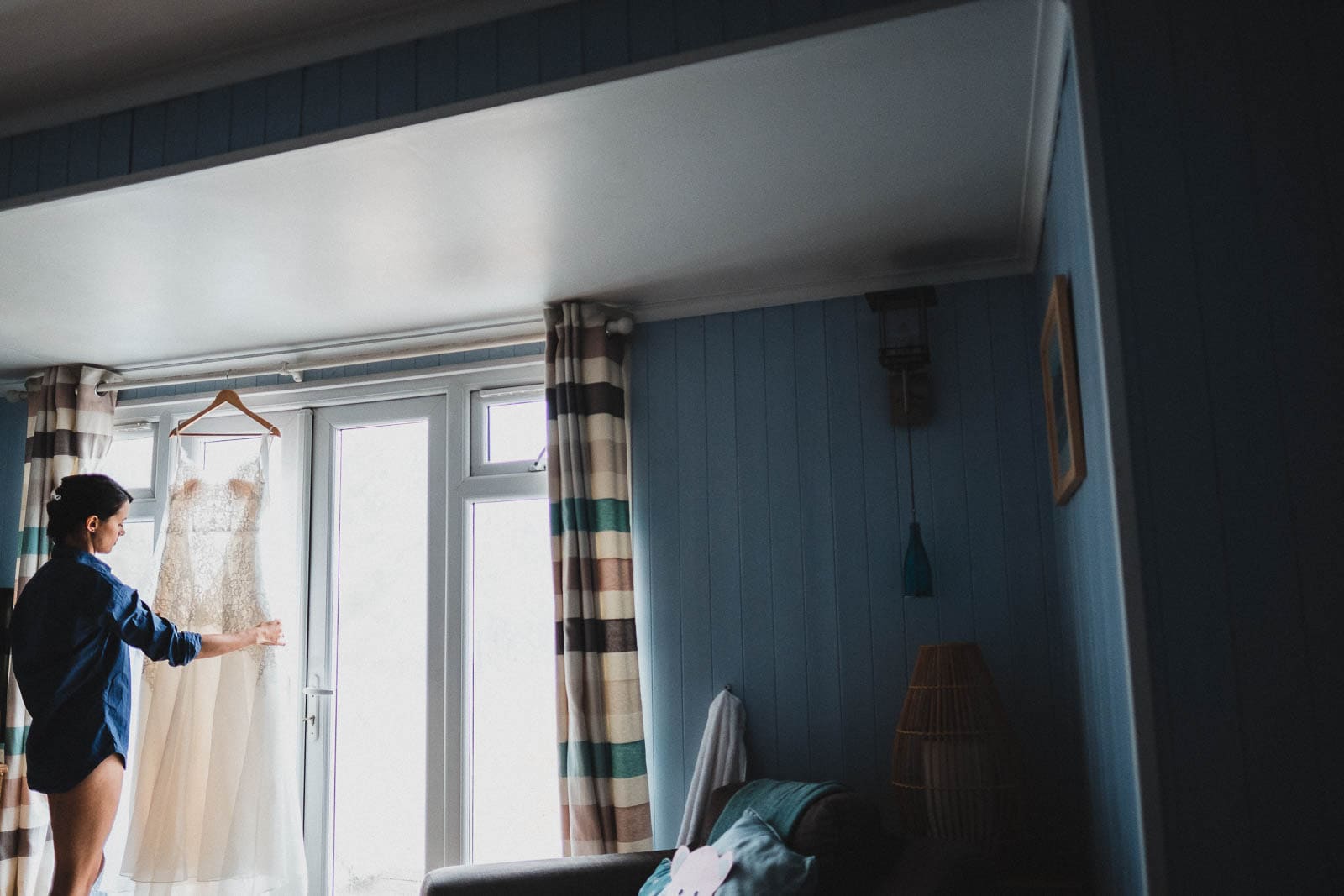 The bride admiring her dress before her Lusty Glaze wedding.